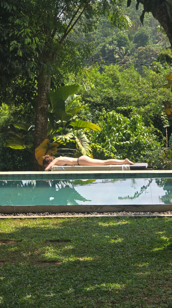 Girl sunbathing by the pool