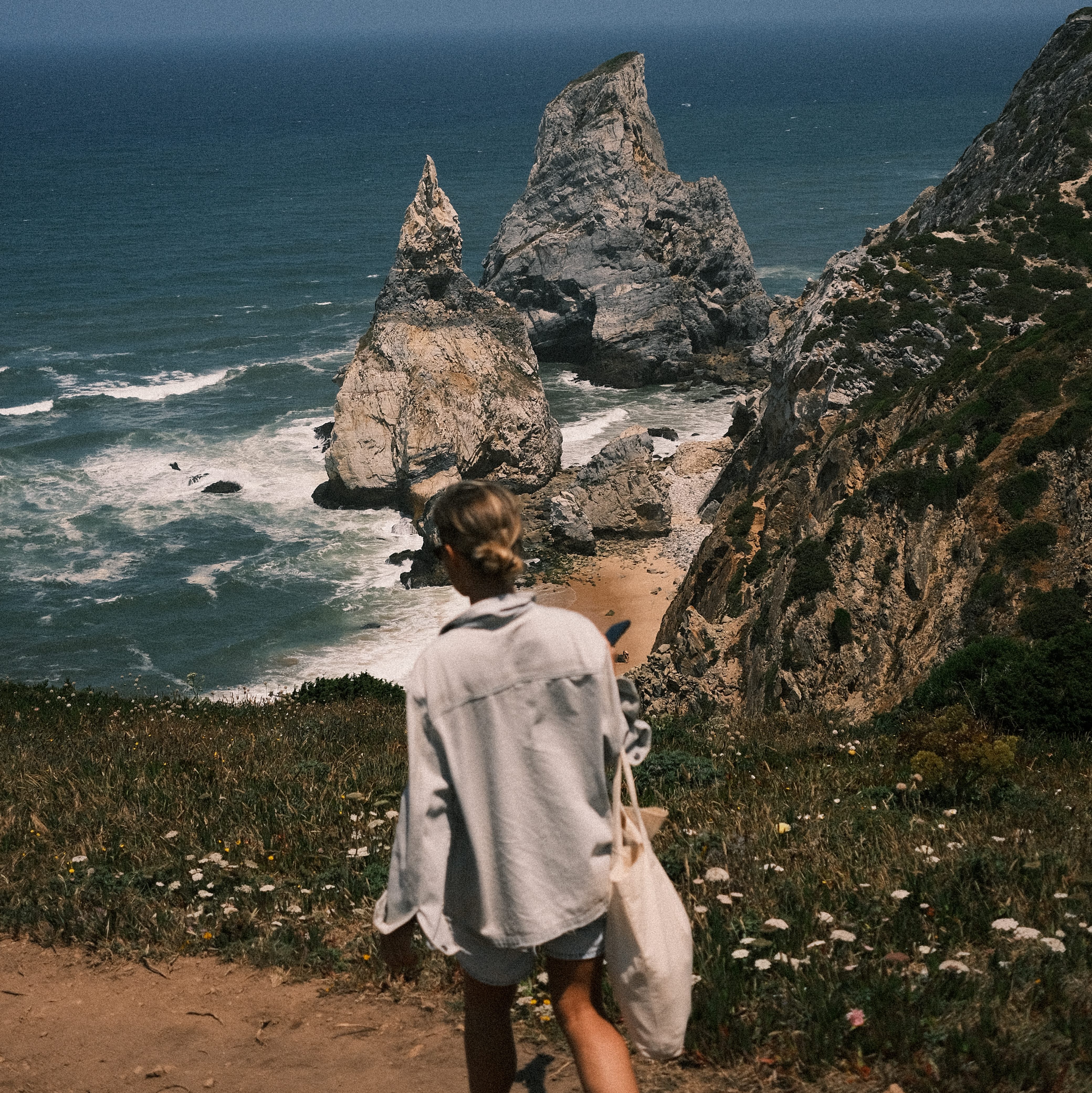 Girl walking by the cliffs in Cabo da Roca